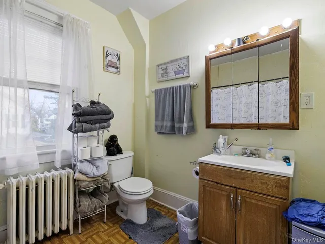 a bathroom with a toilet sink and mirror