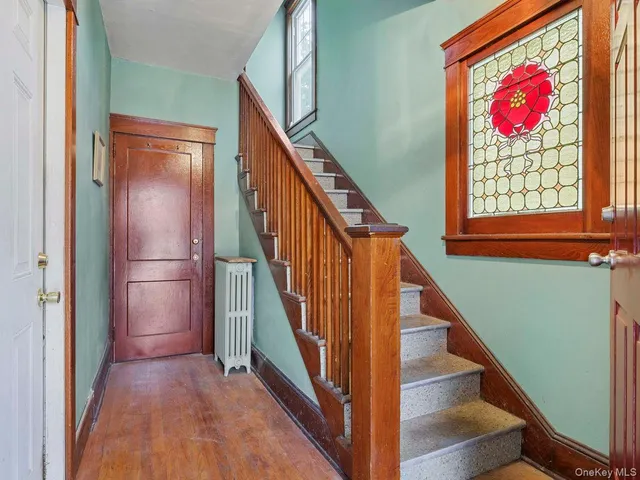 a view of an entryway with wooden floor
