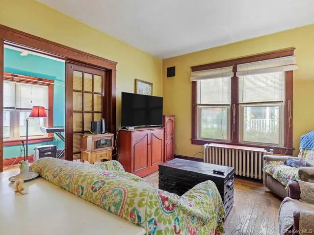 a bedroom with furniture and a flat screen tv