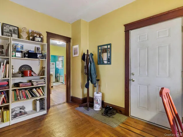 a view of a bedroom with clothes and shoes