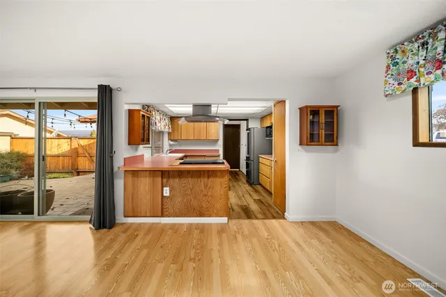 a kitchen with granite countertop stainless steel appliances a stove refrigerator and cabinets