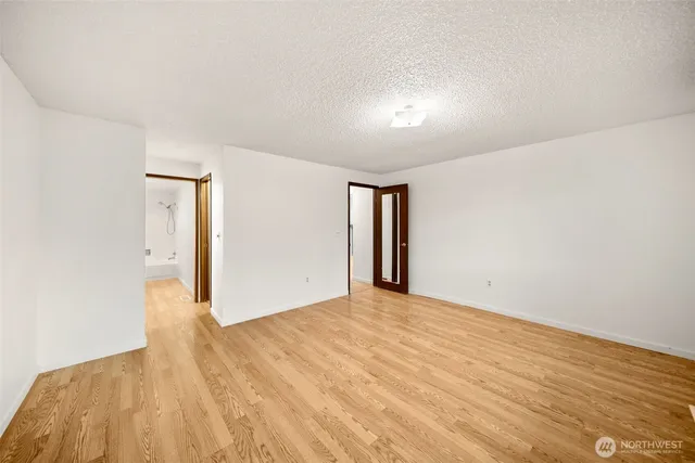 a bathroom with a tub shower vanity and a sink