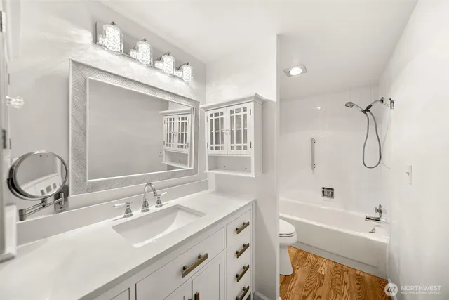 a bathroom with a bath tub with a shower