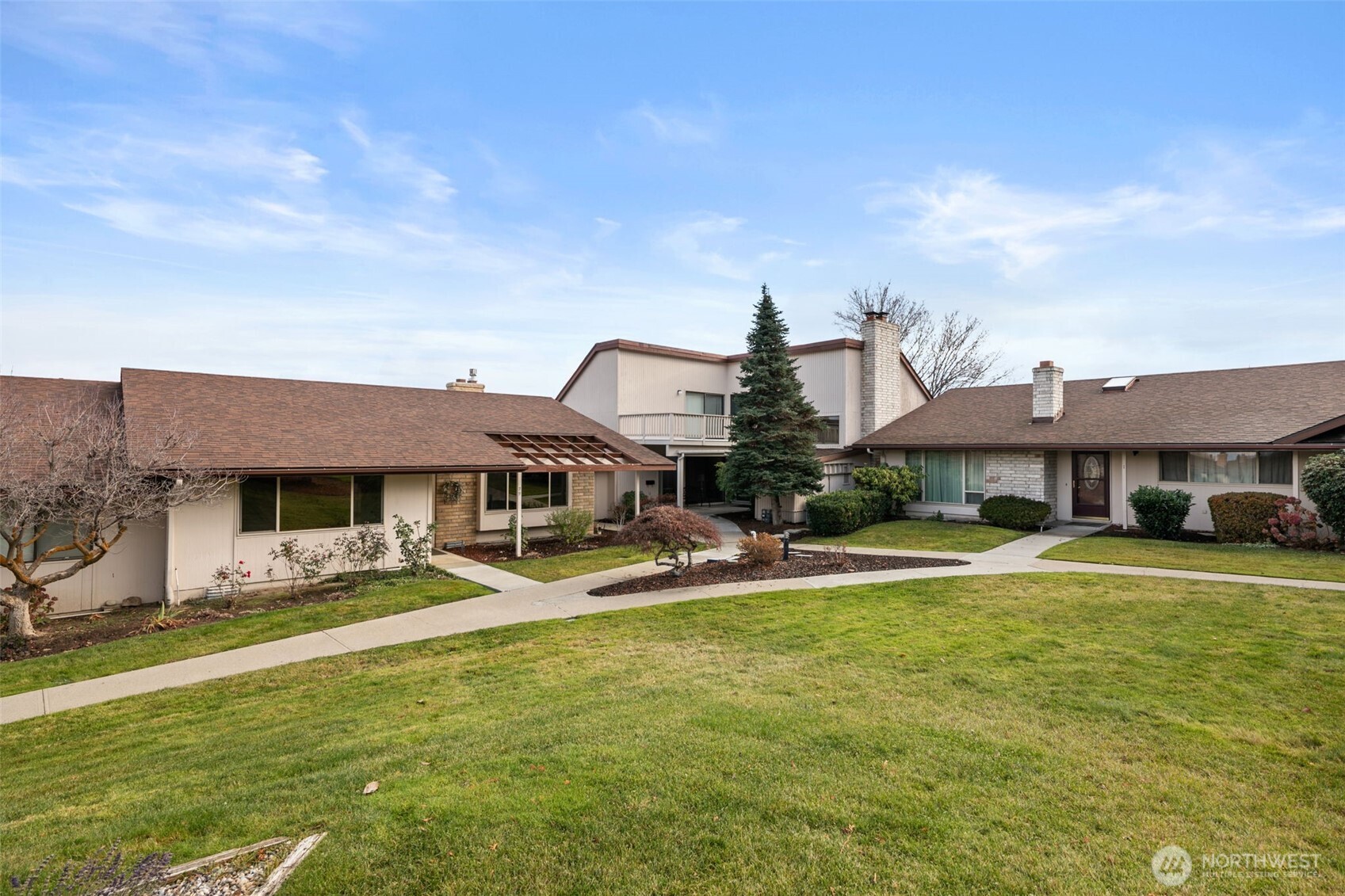 300 South Elliott Avenue, Unit 29 Wenatchee, WA 98801 - Photo 34 of 36 a view of a house with a big yard and a large tree