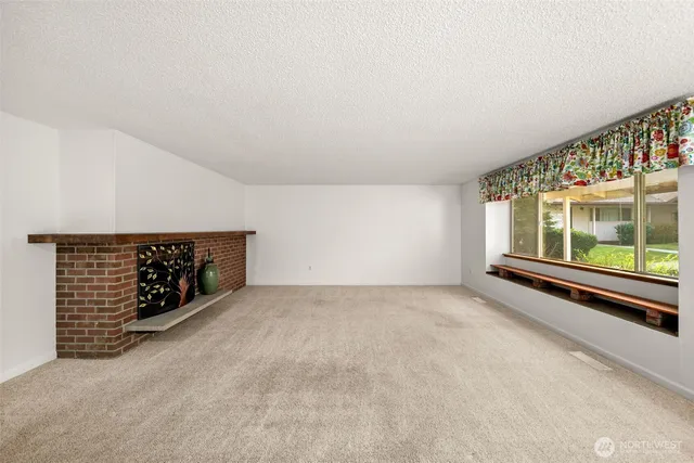 a view of an empty room with a ceiling fan