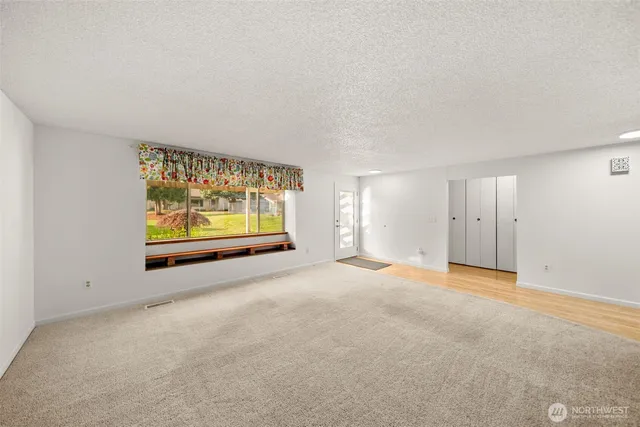 a room with a bed and a large window