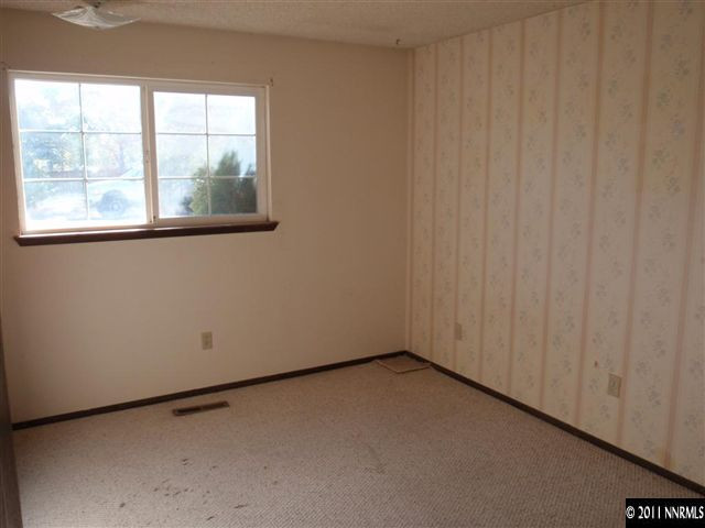 235 Ring Road Dayton, NV 89403 - Photo 8 of 13 a view of an empty room with a window