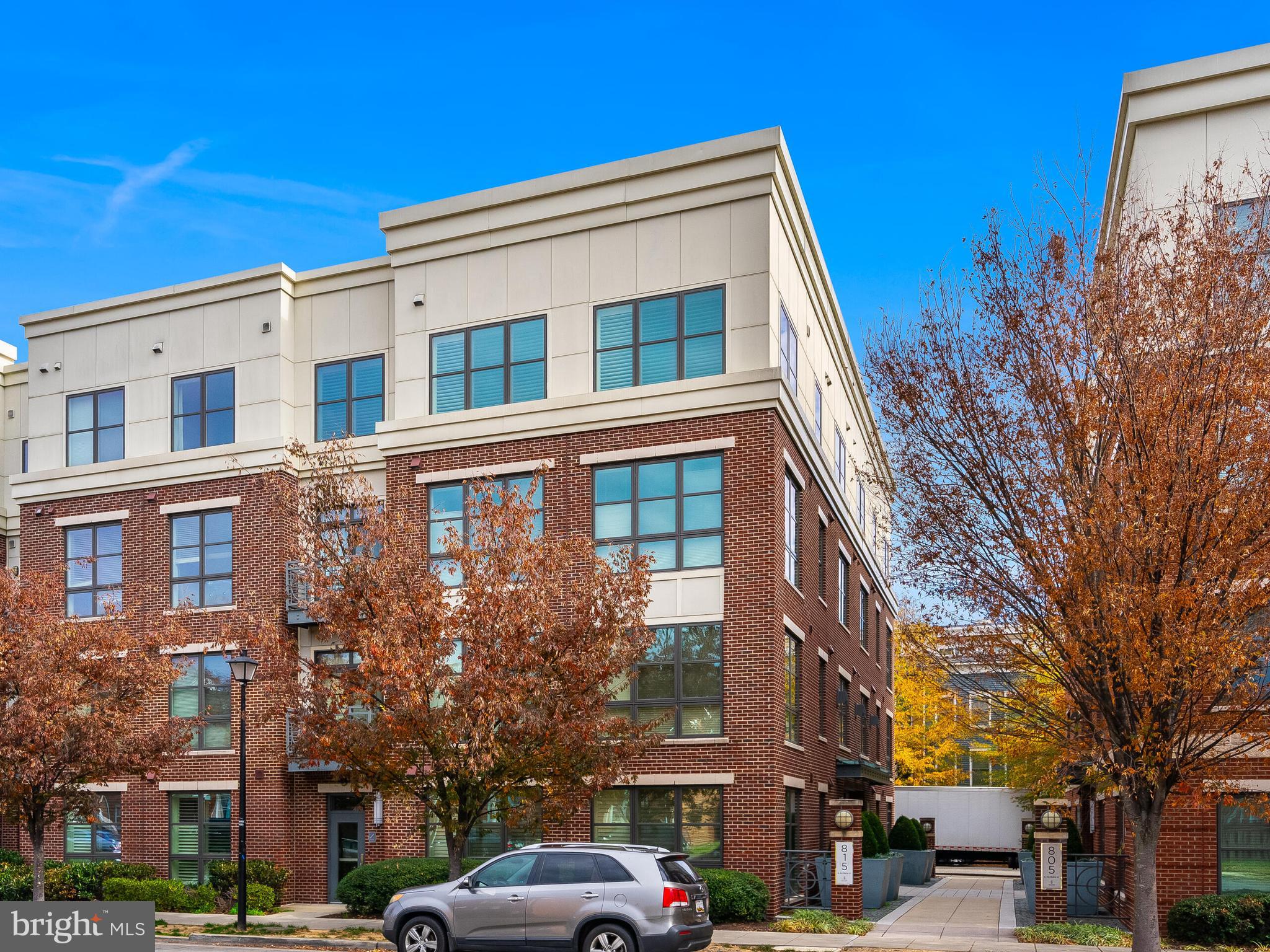 815 North Patrick Street, Unit 402 Alexandria, VA 22314 - Photo 1 of 23 a front view of a building with lot of cars and trees