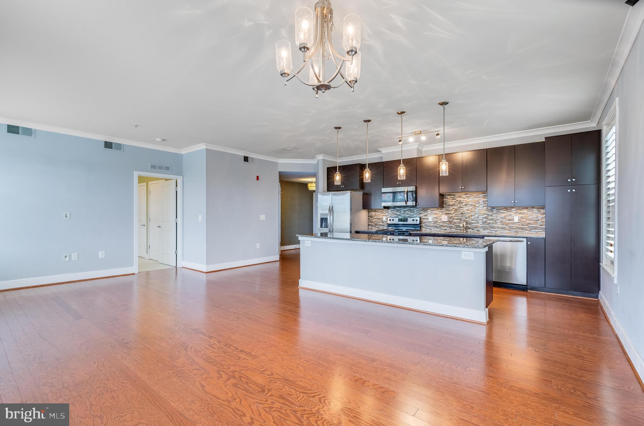 815 North Patrick Street, Unit 402 Alexandria, VA 22314 - Photo 11 of 23 a large kitchen with hardwood and a refrigerator