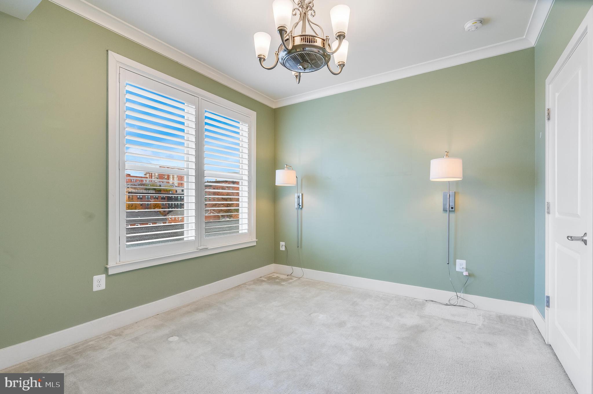 815 North Patrick Street, Unit 402 Alexandria, VA 22314 - Photo 13 of 23 a view of a livingroom with a chandelier fan and a window
