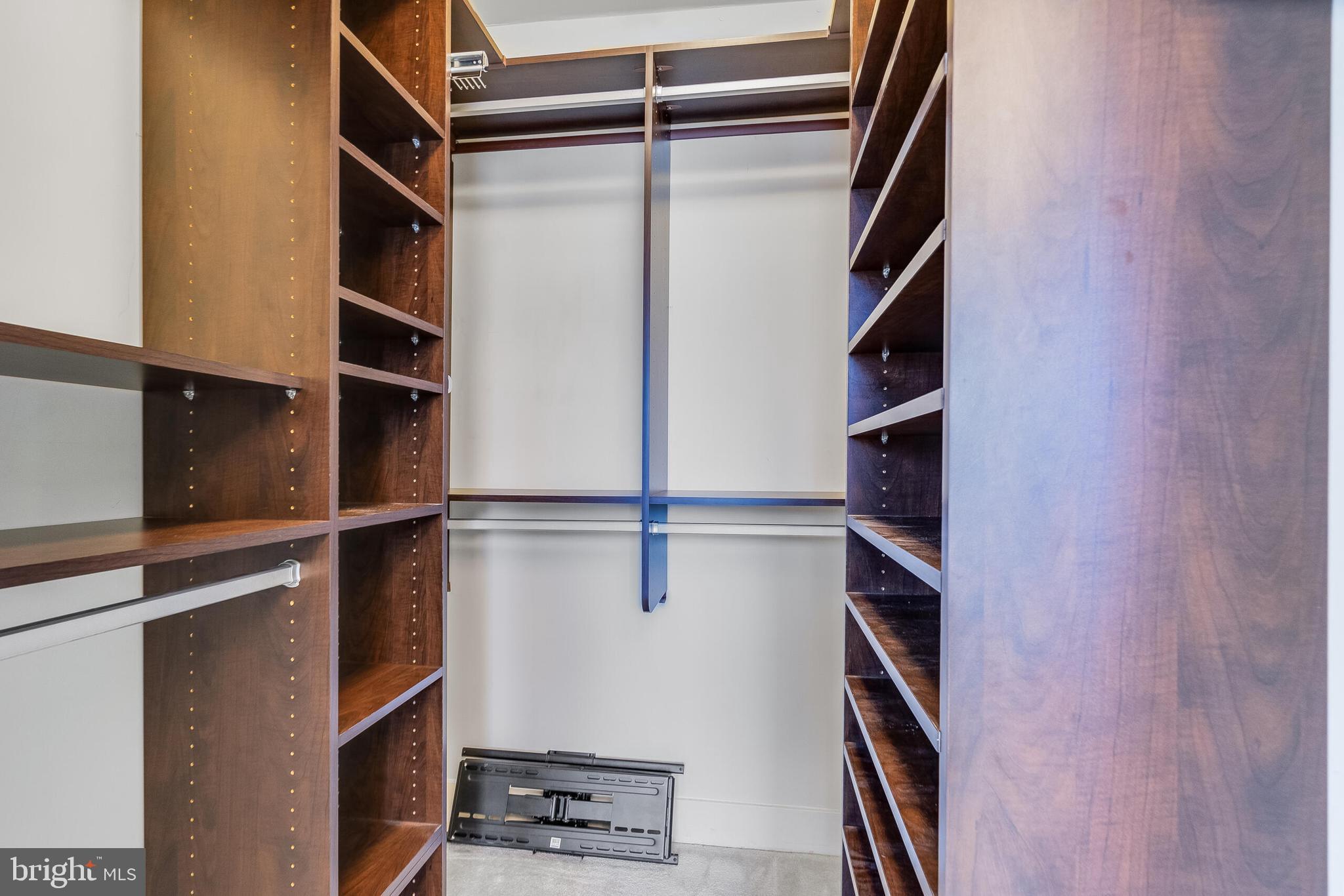 815 North Patrick Street, Unit 402 Alexandria, VA 22314 - Photo 18 of 23 a view of walk in closet with clothes and shoes