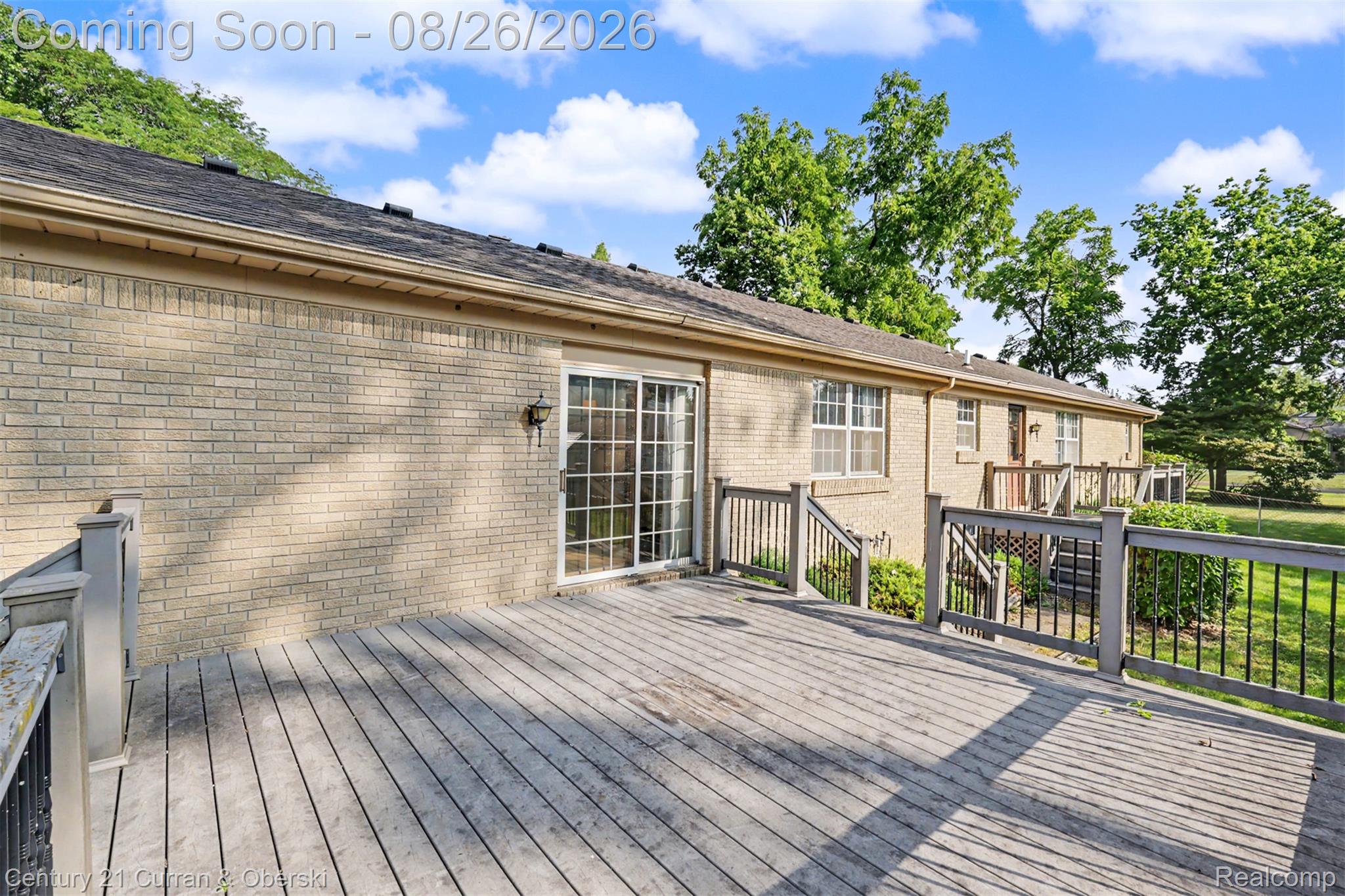 18227 Meridian Road Grosse Ile, MI 48138 - Photo 20 of 23 Expansive deck with a sliding glass door and brick exterior