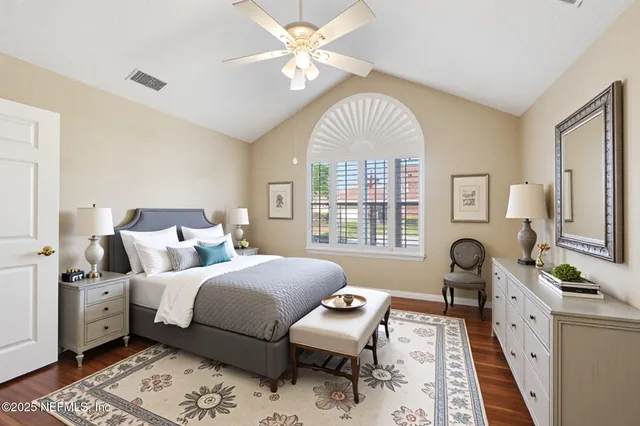 a living room with furniture a fireplace and a large window