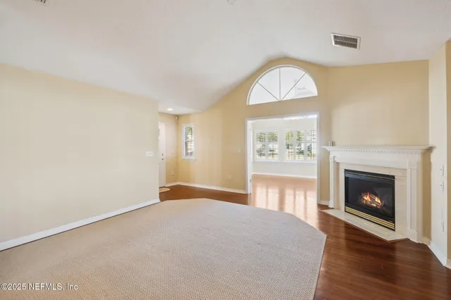 a view of an empty room with a kitchen