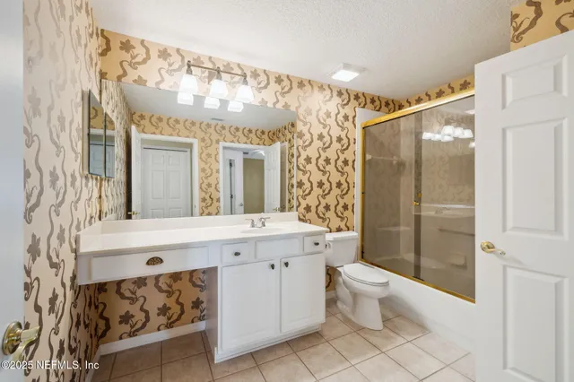 an aerial view of house with yard and lake view