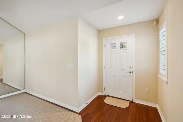 a living room with furniture kitchen view and a flat screen tv