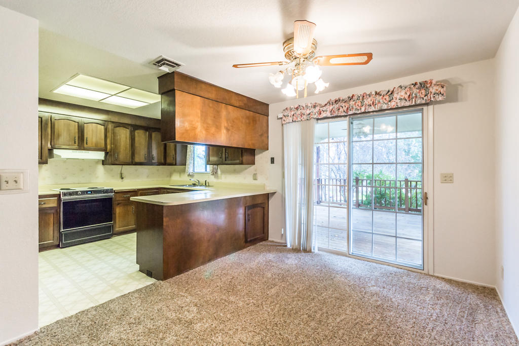 12651 Williamson Road Redding, CA 96003 - Photo 11 of 39 a kitchen with a stove a sink and a refrigerator