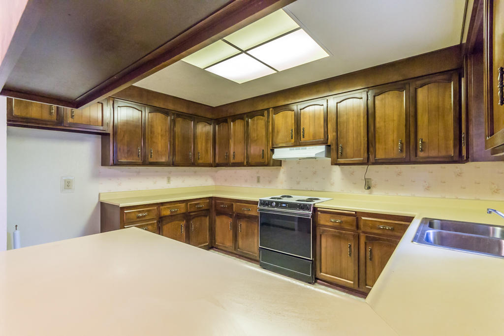 12651 Williamson Road Redding, CA 96003 - Photo 13 of 39 a kitchen with stainless steel appliances granite countertop sink stove and refrigerator