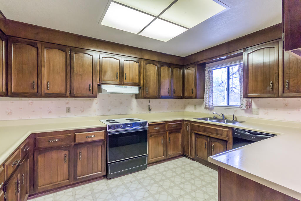 12651 Williamson Road Redding, CA 96003 - Photo 14 of 39 a kitchen with a sink stove and cabinets