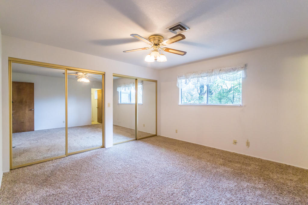 12651 Williamson Road Redding, CA 96003 - Photo 15 of 39 an empty room with fan and windows