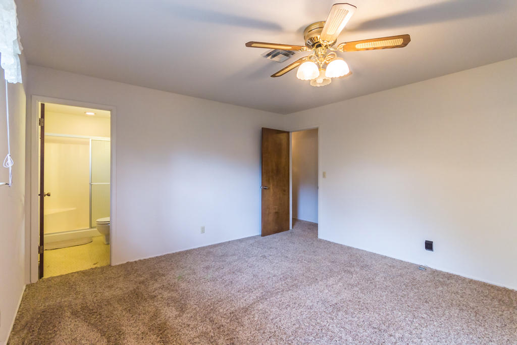 12651 Williamson Road Redding, CA 96003 - Photo 17 of 39 a view of a big room with windows and chandelier fan