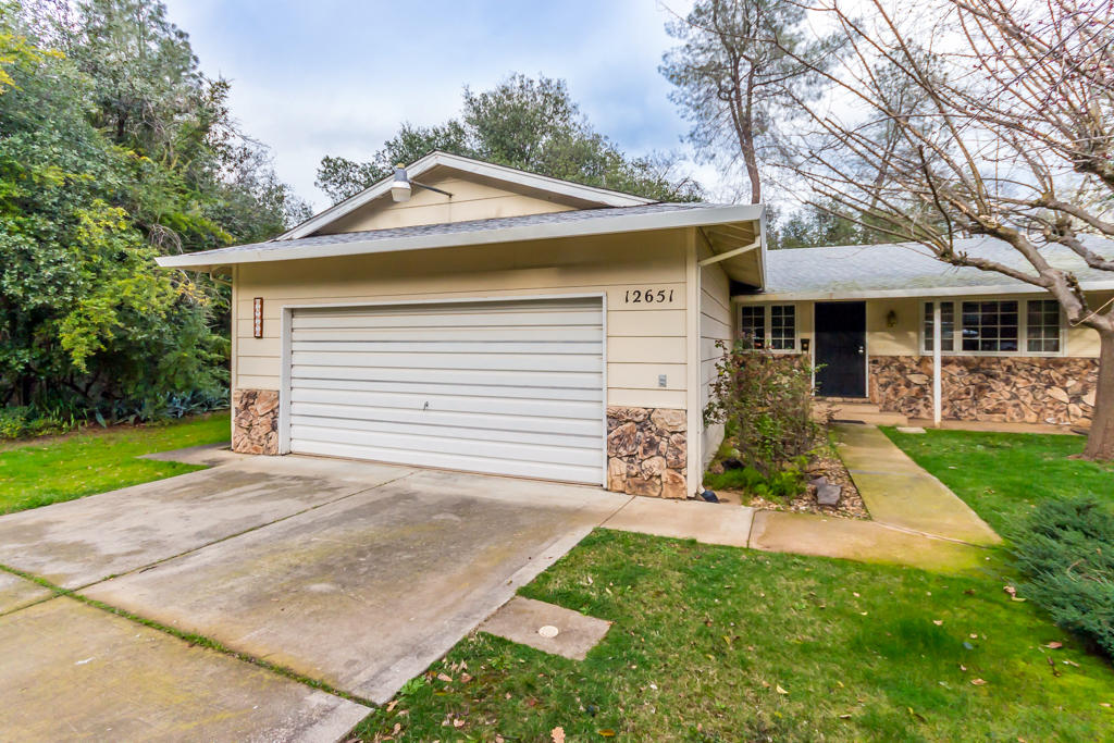 12651 Williamson Road Redding, CA 96003 - Photo 2 of 39 a front view of a house with a garden and yard