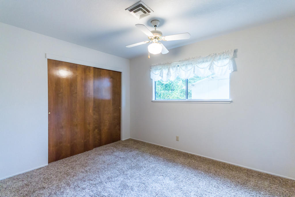 12651 Williamson Road Redding, CA 96003 - Photo 21 of 39 an empty room with windows and fan