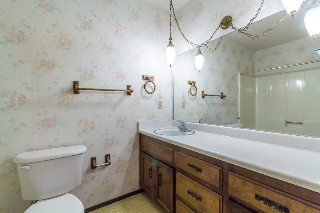 12651 Williamson Road Redding, CA 96003 - Photo 22 of 39 a bathroom with a granite countertop sink a toilet and a mirror