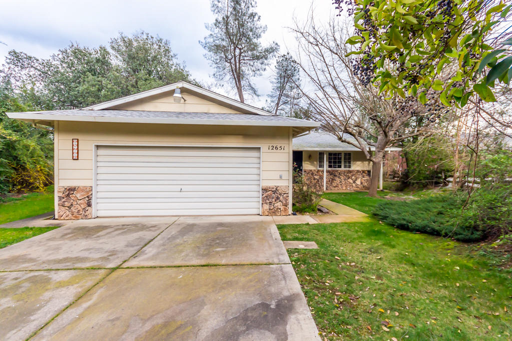 12651 Williamson Road Redding, CA 96003 - Photo 3 of 39 a small white house with a yard and potted plants