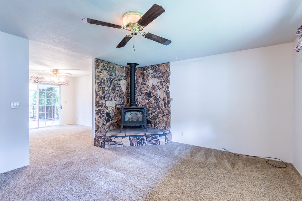 12651 Williamson Road Redding, CA 96003 - Photo 6 of 39 a living room with furniture and a floor to ceiling window