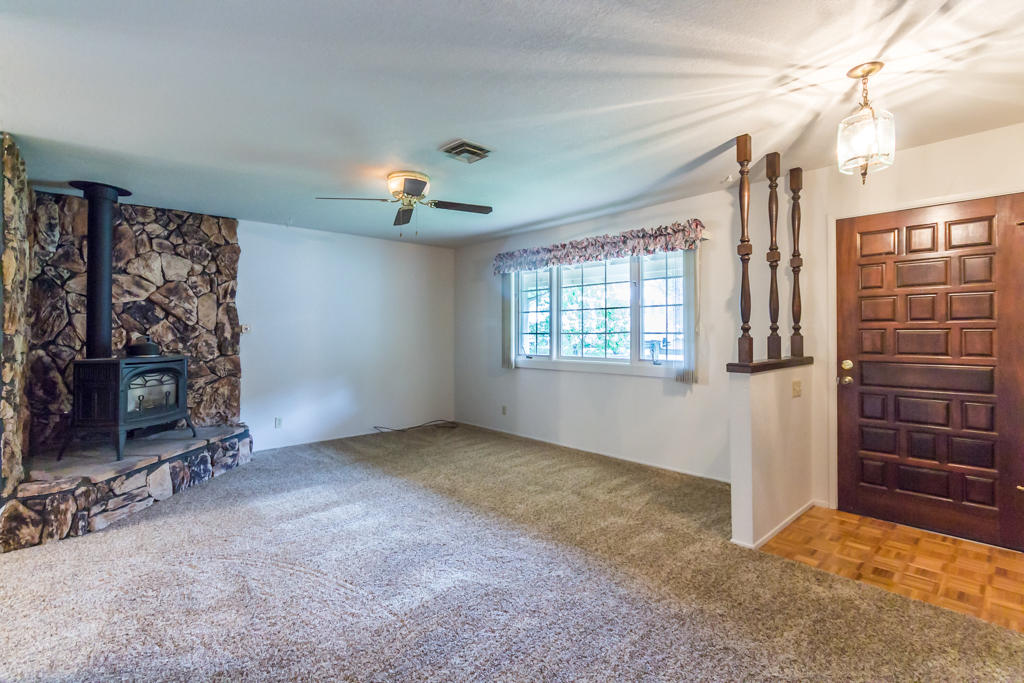 12651 Williamson Road Redding, CA 96003 - Photo 7 of 39 a view of an empty room with furniture and a window