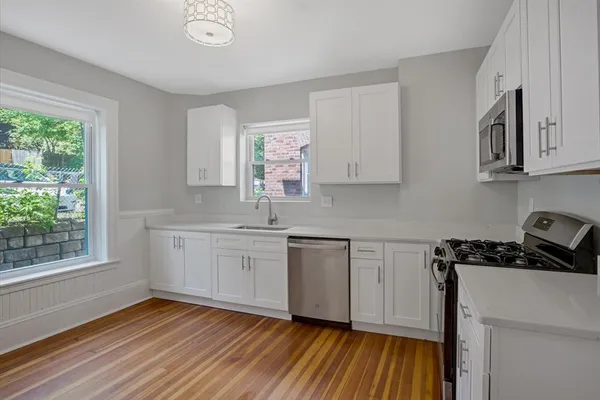 a kitchen with sink window and cabinets
