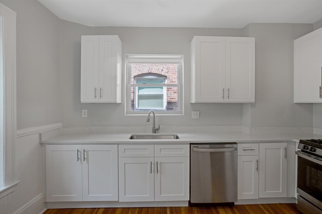 112 Winthrop Road, Unit 5 Brookline, MA 02445 - Photo 6 of 21 a kitchen with white cabinets and sink