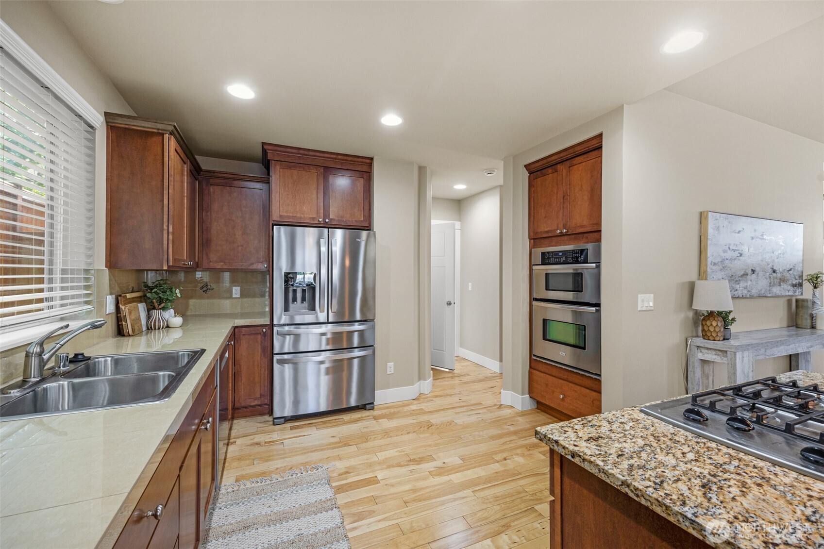 3605 231 Place Southeast Bothell, WA 98021 - Photo 5 of 38 a kitchen with stainless steel appliances granite countertop a refrigerator stove and oven