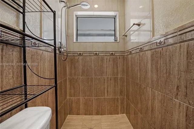 a bathroom with a shower and a sink