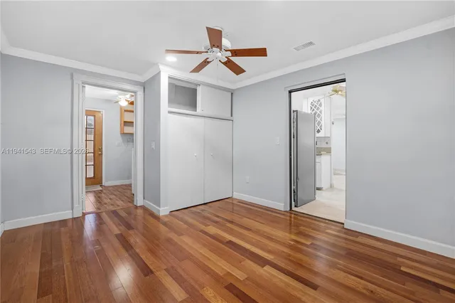 a view of empty room with wooden floor