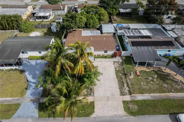 an aerial view of a house with a yard basket ball court and outdoor seating
