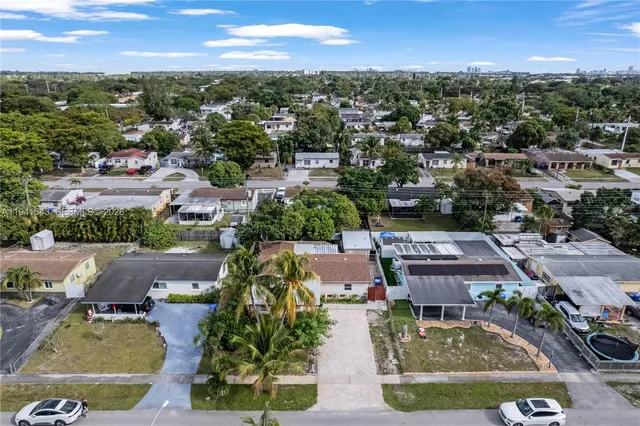an aerial view of a house with garden space and lake view