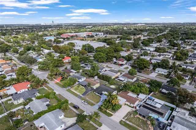 an aerial view of a house with garden space and street view