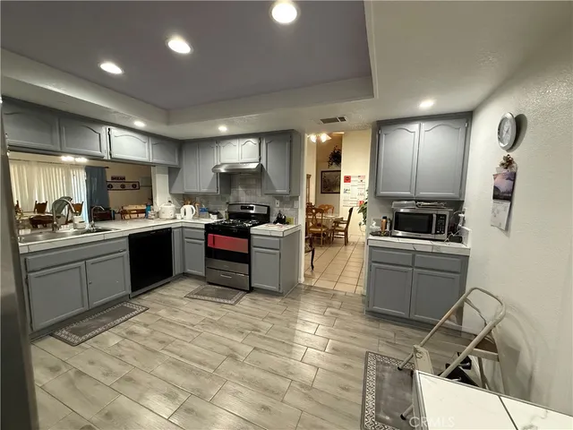 a kitchen with a sink stainless steel appliances and counter space