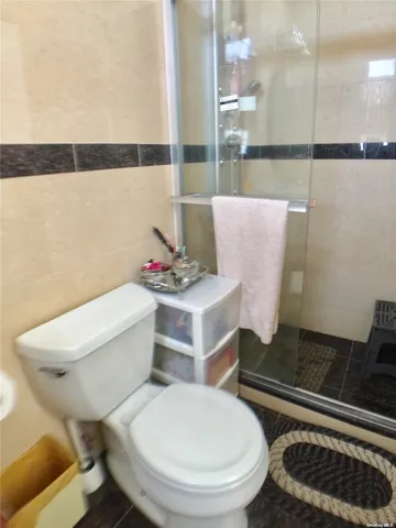 a bathroom with a toilet and a shower