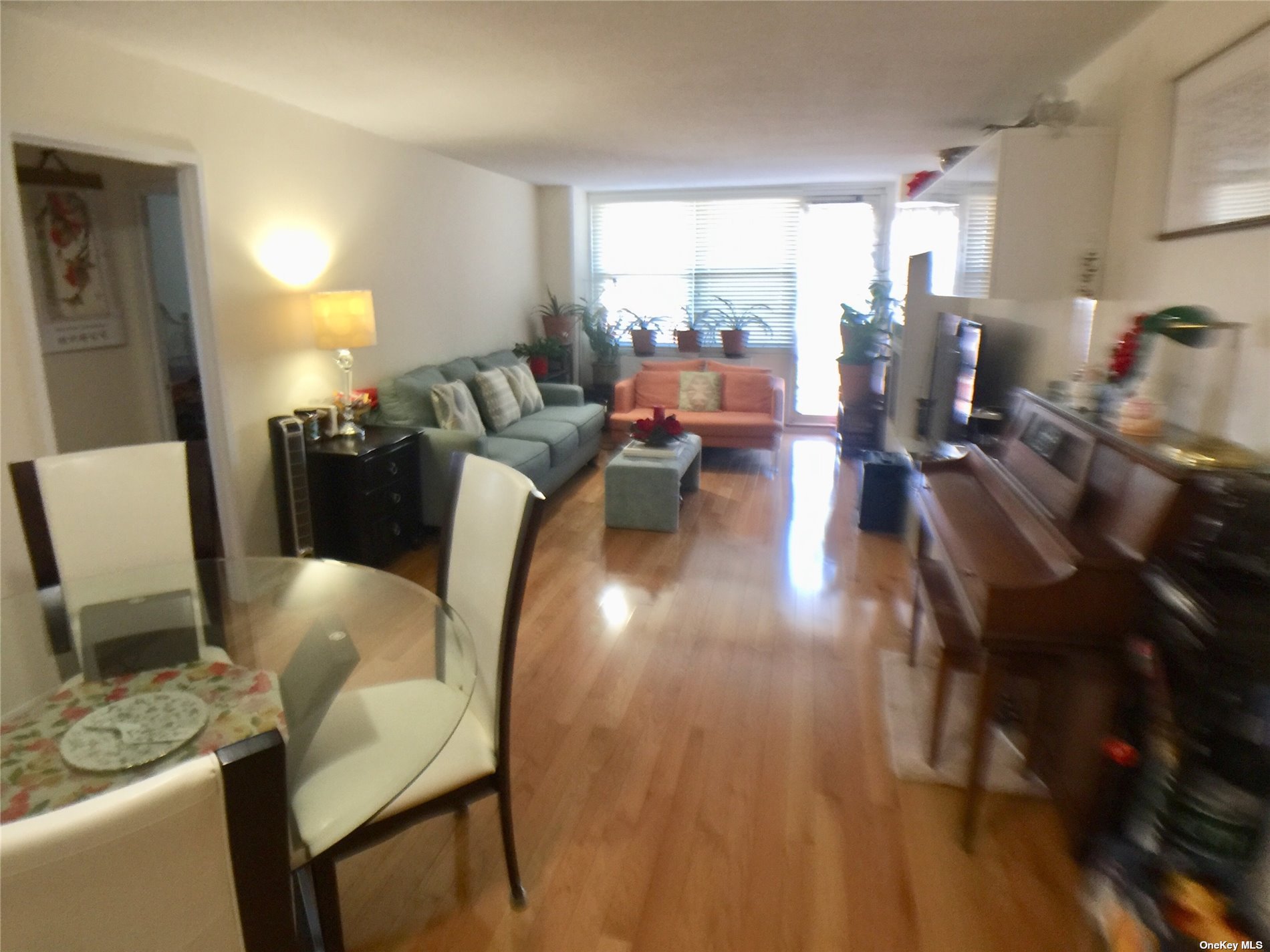 41-40 Union Street, Unit D Queens, NY 11355 - Photo 4 of 18 a living room with furniture and a table