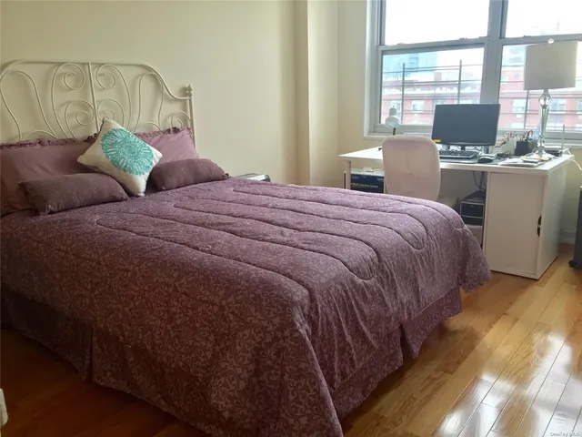 a bedroom with a bed and large windows