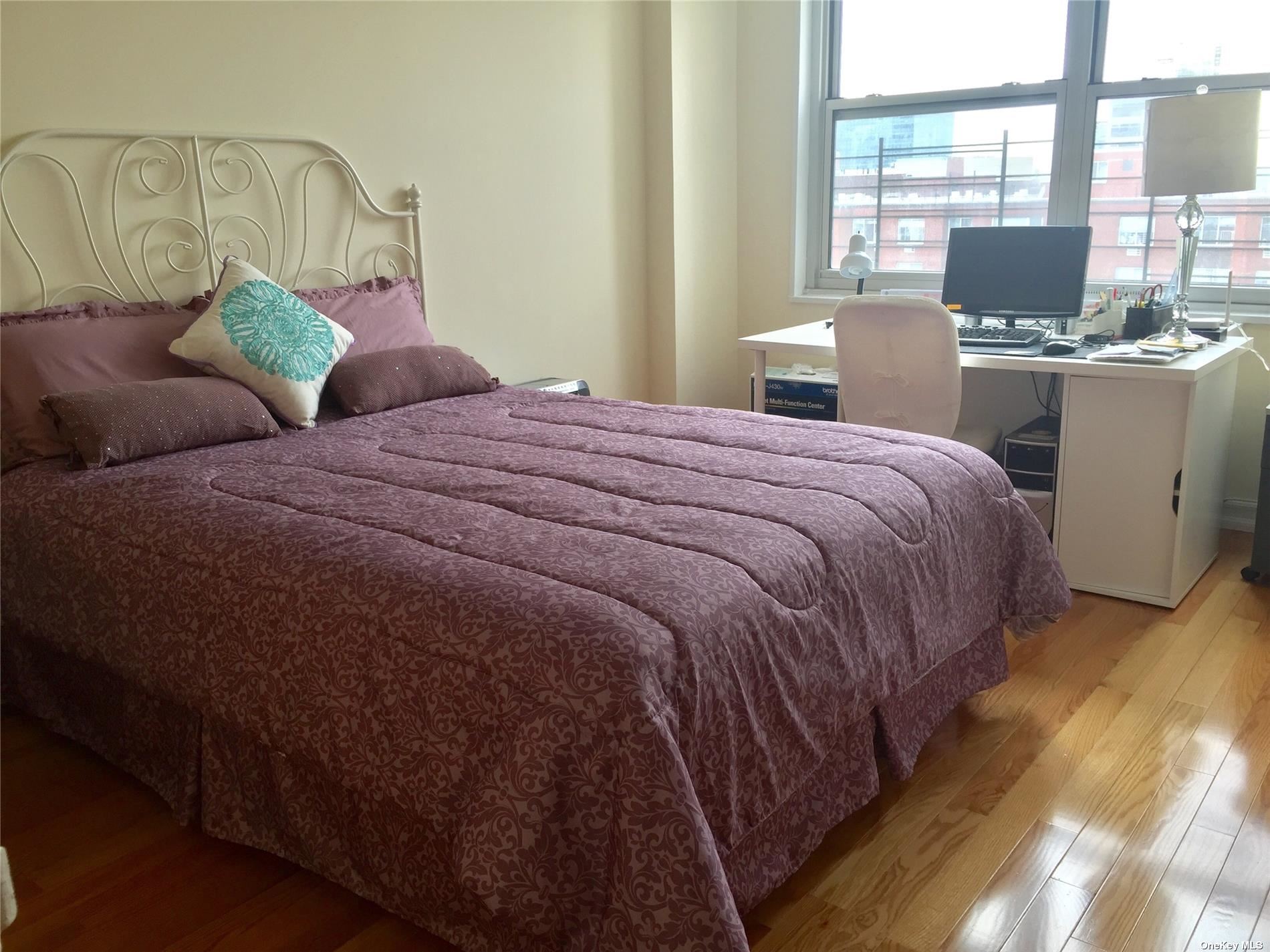 41-40 Union Street, Unit D Queens, NY 11355 - Photo 10 of 18 a bedroom with a bed and large windows