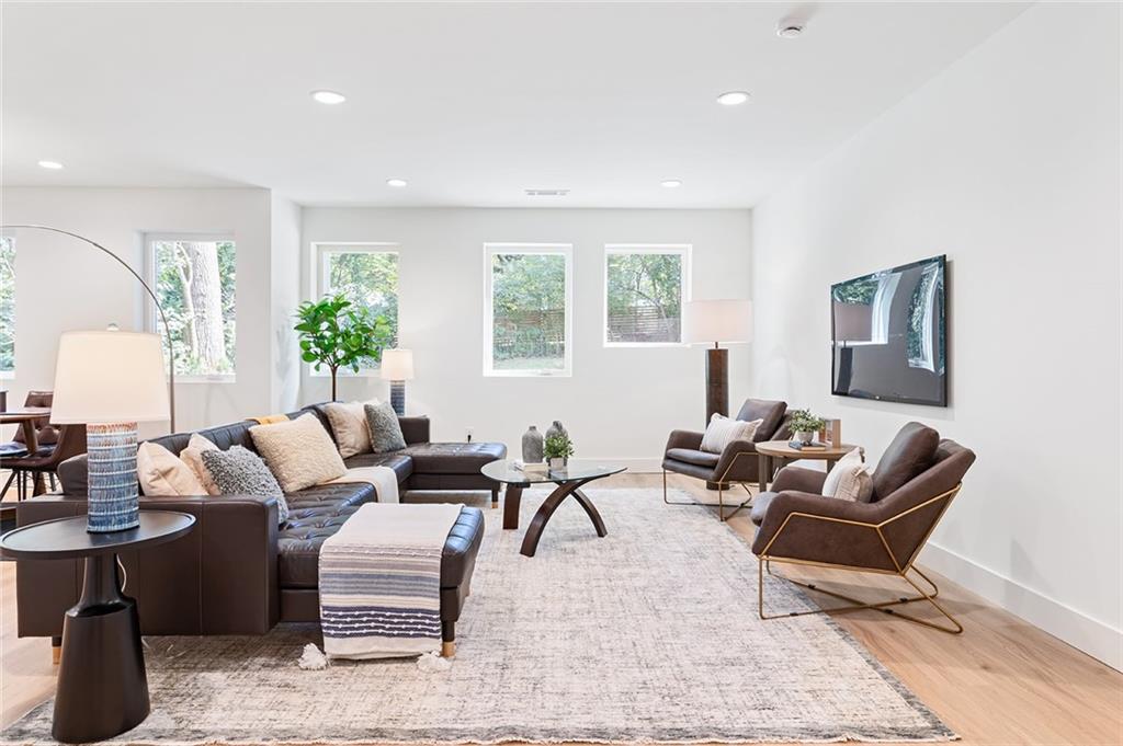 1205 Holly Street Northwest, Unit B Atlanta, GA 30318 - Photo 29 of 81 a living room with furniture wooden floor and a large window