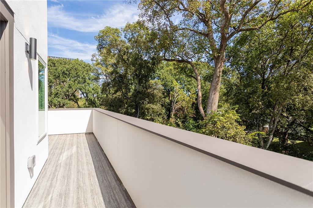 1205 Holly Street Northwest, Unit B Atlanta, GA 30318 - Photo 37 of 81 a view of balcony with wooden floor and fence