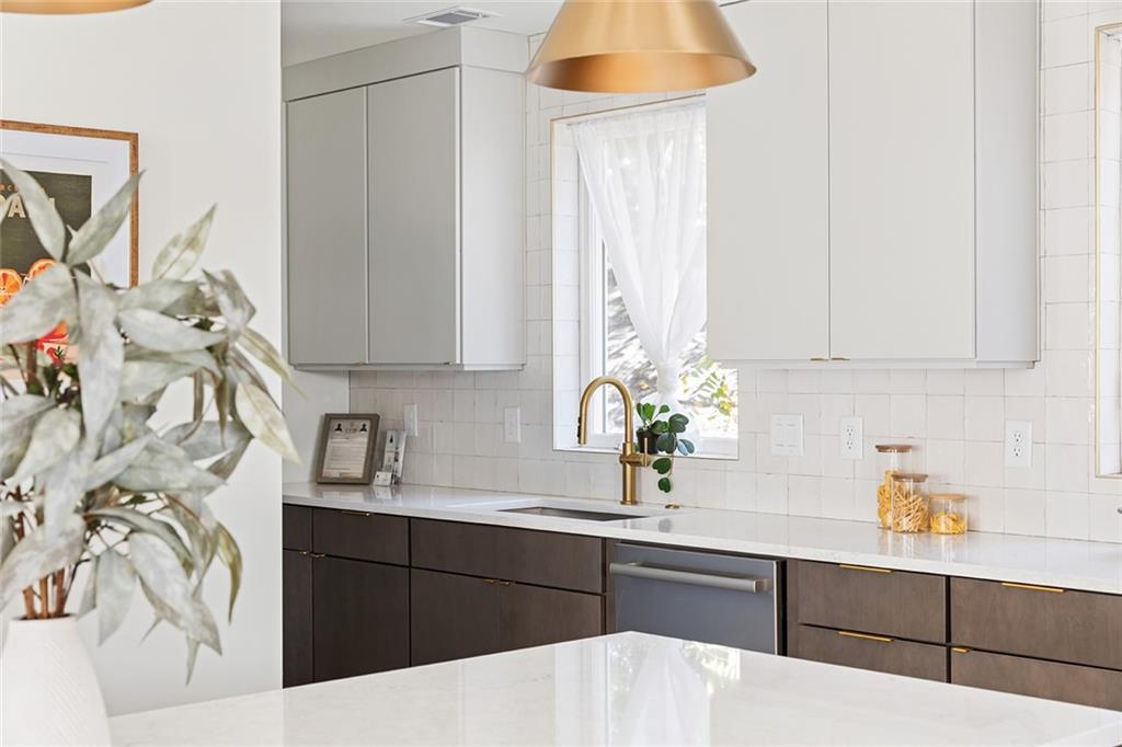 1205 Holly Street Northwest, Unit B Atlanta, GA 30318 - Photo 5 of 81 a kitchen with a sink a stove and cabinets