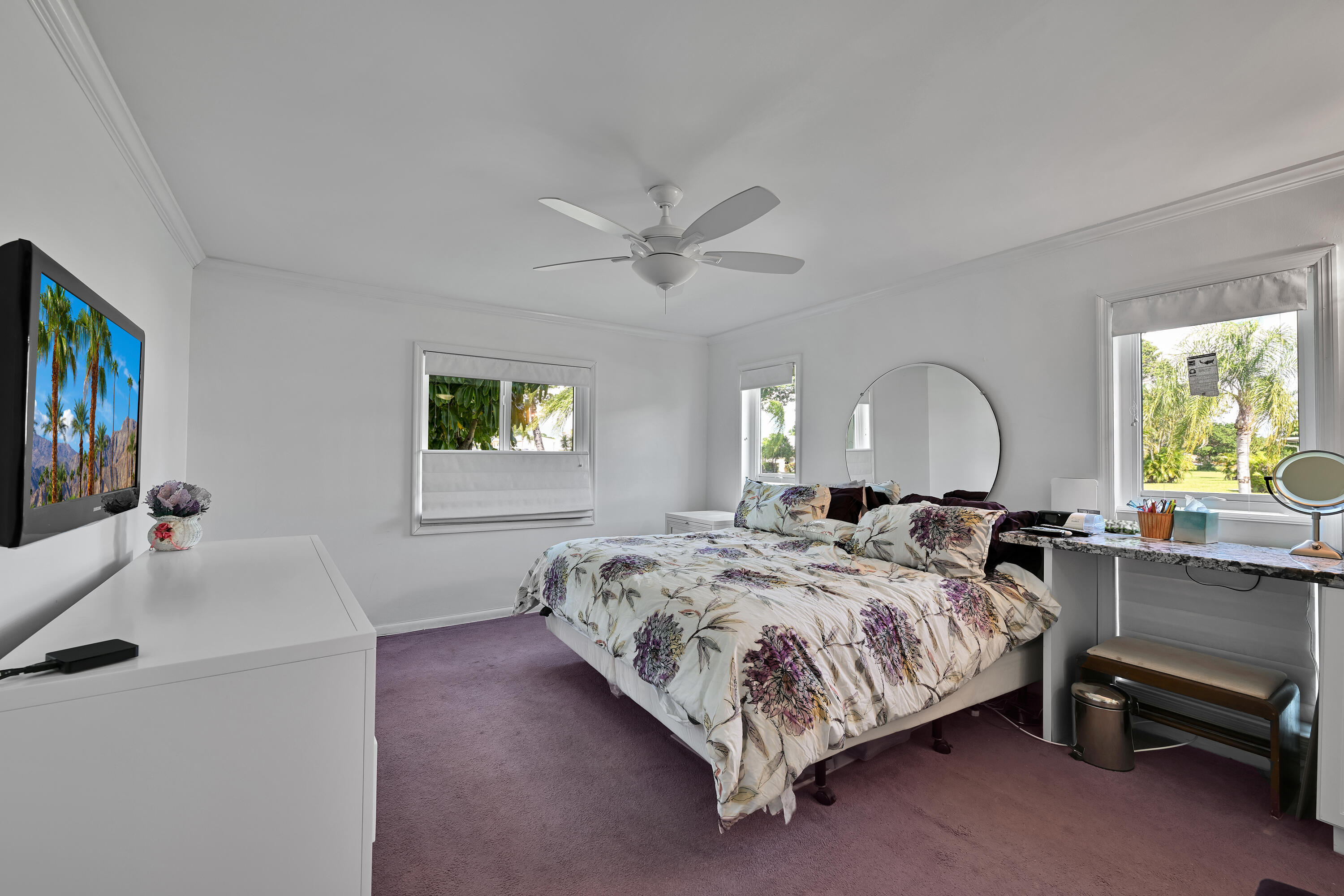 13791 Flora Place, Unit D Delray Beach, FL 33484 - Photo 16 of 24 a bedroom with a bed a couch and a flat screen tv