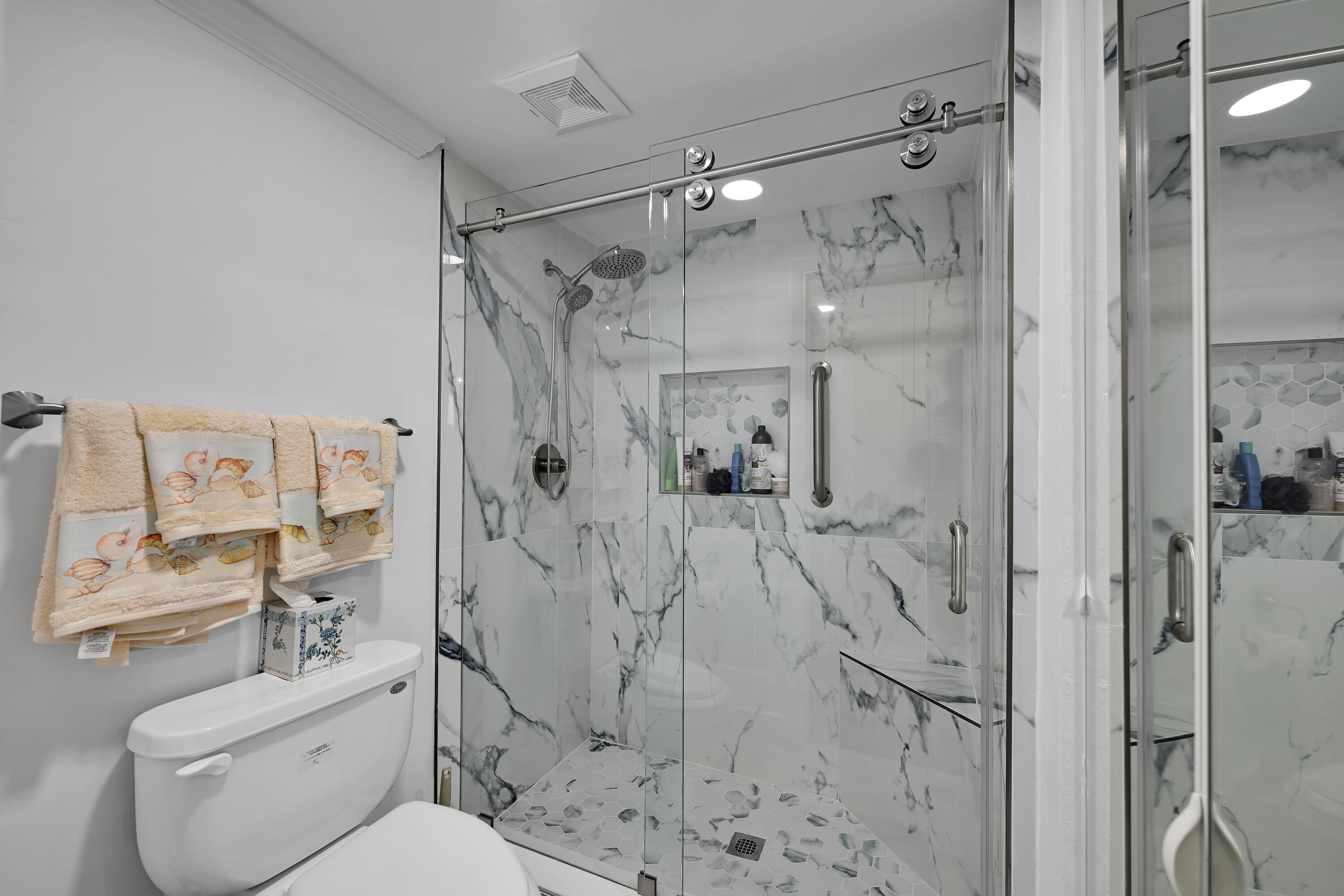 13791 Flora Place, Unit D Delray Beach, FL 33484 - Photo 18 of 24 a bathroom with a shower toilet and sink