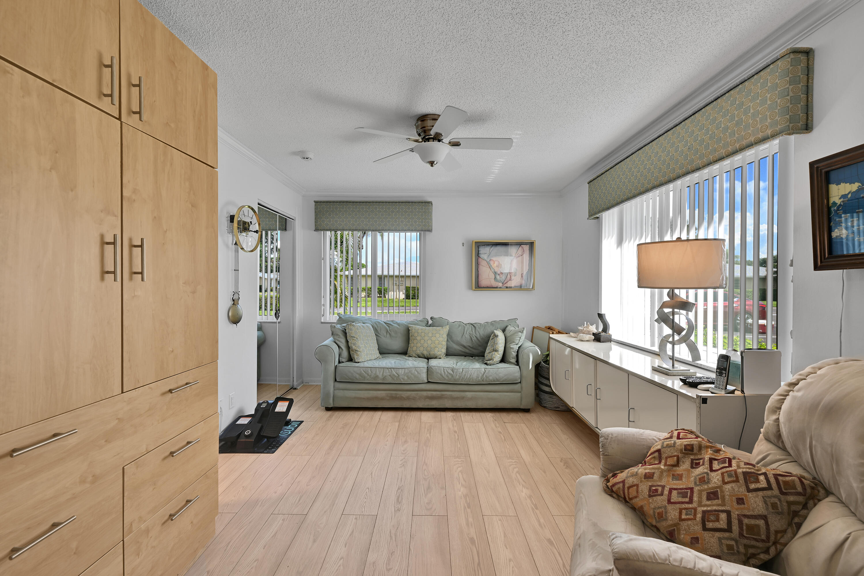13791 Flora Place, Unit D Delray Beach, FL 33484 - Photo 19 of 24 a living room with furniture and a flat screen tv